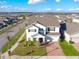 Aerial shot showcasing a home with driveway in a residential area with nearby trees at 9228 Halsey Dr, Groveland, FL 34736