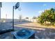 Spacious backyard features a custom brick patio, fire pit, mature tree, and basketball hoop at 9228 Halsey Dr, Groveland, FL 34736