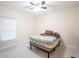 Bright bedroom featuring a window and a full-sized bed with a patterned coverlet at 9228 Halsey Dr, Groveland, FL 34736