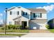 Charming two-story home with landscaped yard, brick driveway, and an attached garage at 9228 Halsey Dr, Groveland, FL 34736