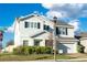 Lovely home with a neat front yard, brick driveway, attached garage, and streetlamp at 9228 Halsey Dr, Groveland, FL 34736