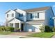 Beautiful home with a brick driveway, attached garage, manicured front yard, and charming curb appeal at 9228 Halsey Dr, Groveland, FL 34736