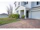 Inviting front entrance with a brick walkway surrounded by lush greenery at 9228 Halsey Dr, Groveland, FL 34736