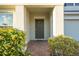 Close-up of the front entrance with a brick path and landscaped bushes at 9228 Halsey Dr, Groveland, FL 34736