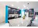 Modern kitchen features granite countertops, dark wood cabinetry, and access to dining area at 9228 Halsey Dr, Groveland, FL 34736