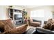 Cozy living room with ample seating, a large television, and natural light creating a welcoming atmosphere at 9228 Halsey Dr, Groveland, FL 34736