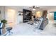 Open-concept living room with a cozy seating area, fireplace, and access to kitchen and dining at 9228 Halsey Dr, Groveland, FL 34736