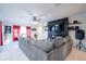 Comfortable living area with plush sofa, tile flooring, fireplace, and plenty of natural light at 9228 Halsey Dr, Groveland, FL 34736