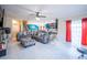 Open-concept living space featuring a large sectional sofa, tile flooring, and view of the kitchen at 9228 Halsey Dr, Groveland, FL 34736