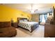 Spacious main bedroom with a beautiful bed, ample lighting, and comfortable seating at 9228 Halsey Dr, Groveland, FL 34736
