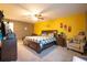 Bright main bedroom with a beautiful bed, ample lighting, and comfortable seating at 9228 Halsey Dr, Groveland, FL 34736
