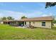 Lush backyard featuring a covered patio and ample space for outdoor enjoyment and entertainment at 9236 Baton Rouge Dr, Orlando, FL 32818