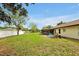 Large backyard with well-kept lawn, fenced perimeter, and a patio, creating a private outdoor retreat at 9236 Baton Rouge Dr, Orlando, FL 32818