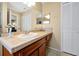Neutral bathroom featuring a tiled vanity with a white sink, complemented by classic white paneled doors at 9236 Baton Rouge Dr, Orlando, FL 32818