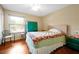 Shot of a bedroom with laminate flooring, window, a bed, and colorful dresser at 9236 Baton Rouge Dr, Orlando, FL 32818