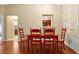 Well-lit dining area featuring hardwood floors and decorative wainscoting, perfect for Gathering meals at 9236 Baton Rouge Dr, Orlando, FL 32818
