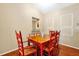 Well-lit dining area featuring hardwood floors and decorative wainscoting, perfect for Gathering meals at 9236 Baton Rouge Dr, Orlando, FL 32818
