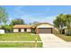 This single story home features a well maintained lawn, covered front porch, and an attached two car garage at 9236 Baton Rouge Dr, Orlando, FL 32818
