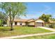 Charming single Gathering home featuring a well maintained lawn, attached garage and lovely curb appeal at 9236 Baton Rouge Dr, Orlando, FL 32818