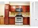 This beautiful kitchen features custom painted cabinets, stainless steel appliances, tile flooring, and ample counter space at 9236 Baton Rouge Dr, Orlando, FL 32818