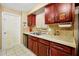 Close-up of the kitchen sink and cabinets with tile backsplash and countertops at 9236 Baton Rouge Dr, Orlando, FL 32818