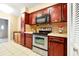 This beautiful kitchen features custom painted cabinets, stainless steel appliances and tile backsplash at 9236 Baton Rouge Dr, Orlando, FL 32818