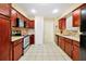 View of the kitchen featuring tile flooring, wooden cabinets, and stainless steel appliances at 9236 Baton Rouge Dr, Orlando, FL 32818