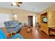 Cozy living room featuring hardwood floors, a ceiling fan, comfortable furniture, and a neutral color palette at 9236 Baton Rouge Dr, Orlando, FL 32818