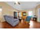 Comfortable living room offering vaulted ceilings, wood floors, ceiling fan, a couch and a rocker at 9236 Baton Rouge Dr, Orlando, FL 32818