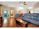 Spacious living room featuring vaulted ceilings, hardwood floors, a ceiling fan and sliding glass doors at 9236 Baton Rouge Dr, Orlando, FL 32818