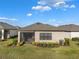 This backyard features a well-maintained lawn, tidy landscaping and a screened-in patio at 938 Braewood Dr, Clermont, FL 34715