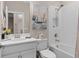 This bathroom features a combined tub and shower with a tile backsplash and a modern vanity at 938 Braewood Dr, Clermont, FL 34715