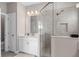 This bathroom features an enclosed shower with tile backsplash, bright vanity and modern fixtures at 938 Braewood Dr, Clermont, FL 34715
