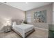 This bedroom features neutral tones and an upholstered headboard and a decorative art piece at 938 Braewood Dr, Clermont, FL 34715