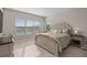 A cozy bedroom with a upholstered bed frame, natural light, and serene color palette at 938 Braewood Dr, Clermont, FL 34715