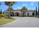 Beautiful clubhouse with stone accents, arched windows, tile roof and well manicured landscaping at 938 Braewood Dr, Clermont, FL 34715