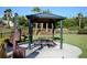 Dog park with a covered seating area and waste disposal station for pet owners at 938 Braewood Dr, Clermont, FL 34715