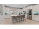 A bright kitchen with white cabinets, a central island with seating, and stainless steel appliances at 938 Braewood Dr, Clermont, FL 34715
