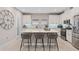 A bright kitchen with white cabinets, a central island with seating, and stainless steel appliances at 938 Braewood Dr, Clermont, FL 34715