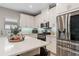 A modern kitchen showcasing stainless steel appliances, white countertops and cabinets at 938 Braewood Dr, Clermont, FL 34715