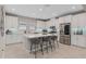 A bright kitchen with white cabinets, a central island with seating, and stainless steel appliances at 938 Braewood Dr, Clermont, FL 34715