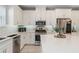 Bright kitchen featuring modern stainless steel appliances, white cabinets and countertops and backsplash at 938 Braewood Dr, Clermont, FL 34715