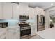 Modern kitchen featuring stainless steel appliances, white cabinets and countertops and backsplash at 938 Braewood Dr, Clermont, FL 34715