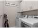 This laundry room includes full sized appliances, storage cabinets and modern conveniences at 938 Braewood Dr, Clermont, FL 34715