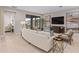 Well-designed living room with comfortable seating, modern art, and a seamless connection to the outdoor space at 938 Braewood Dr, Clermont, FL 34715