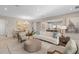 Open-concept living space with kitchen, dining, and living area featuring neutral tones and modern finishes at 938 Braewood Dr, Clermont, FL 34715