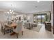 Open-concept living space featuring a dining area, living room, and kitchen with sliding glass doors at 938 Braewood Dr, Clermont, FL 34715
