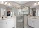 This main bathroom features an enclosed shower with dual sinks, white cabinets and plenty of storage space at 938 Braewood Dr, Clermont, FL 34715