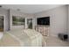 This main bedroom features a decorative dresser with an entertainment center and light, bright, neutral colors at 938 Braewood Dr, Clermont, FL 34715