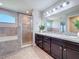 Well-lit bathroom features a spacious shower, soaking tub, and a stylish vanity at 2863 Harlow Ave, St Cloud, FL 34772